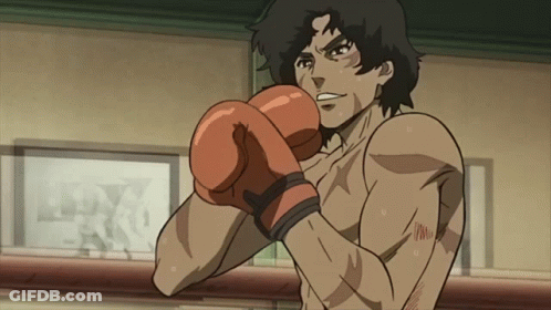 A Man Wearing Boxing Gloves Is Standing In Front Of A Wall With A Picture Of A Man In A Ring GIF