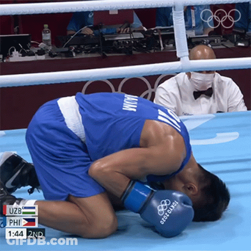 A Man Wearing Boxing Gloves That Say Tokyo 2020 On Them GIF
