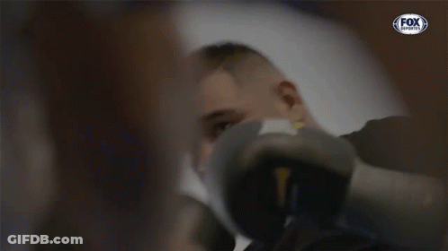 A Man Wearing Boxing Gloves With A Fox Sports Logo GIF