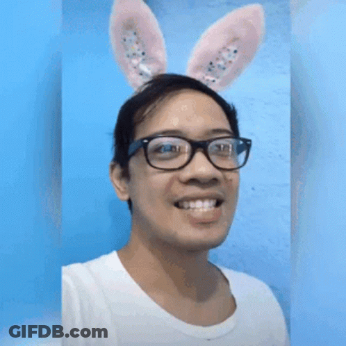 A Man Wearing Bunny Ears And Glasses Is Making A Funny Face GIF