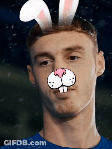 A Man Wearing Bunny Ears On His Head Looks At The Camera GIF