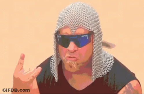 A Man Wearing Chain Mail And Sunglasses Is Making A Funny Face And Giving The Middle Finger . GIF