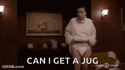 A Man Wearing Diapers And A Sweater Is Standing In A Living Room With The Words `` Can I Get A Jug '' . GIF