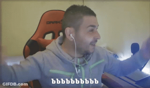 A Man Wearing Ear Buds And A Grey Hoodie Is Pointing At The Camera With The Words He He He And He Written Below Him GIF