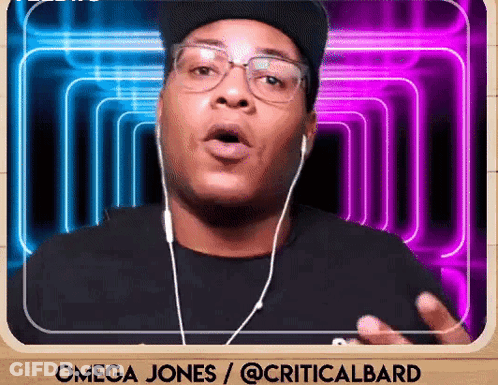 A Man Wearing Ear Buds And A Hat Says Omega Jones / @Criticalbard GIF