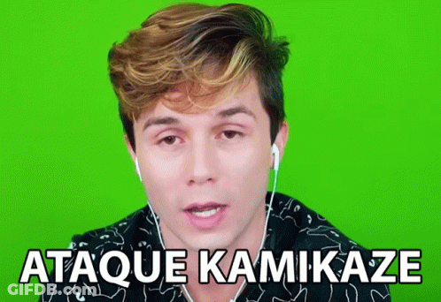 A Man Wearing Ear Buds Says " Ataque Kamikaze " In Front Of A Green Screen GIF