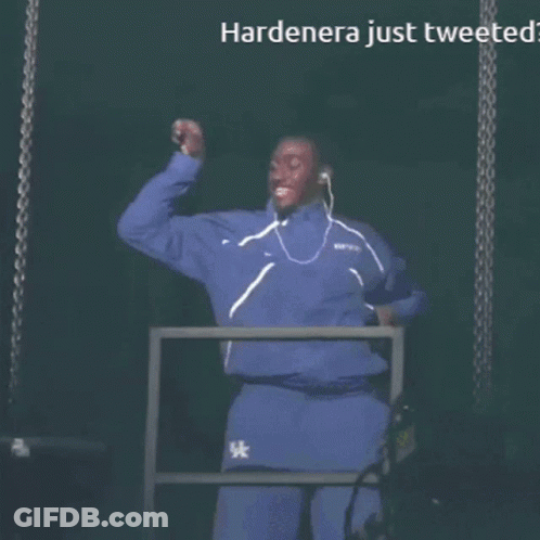 A Man Wearing Ear Buds Stands In Front Of A Screen That Says Hardenera Just Tweeted GIF