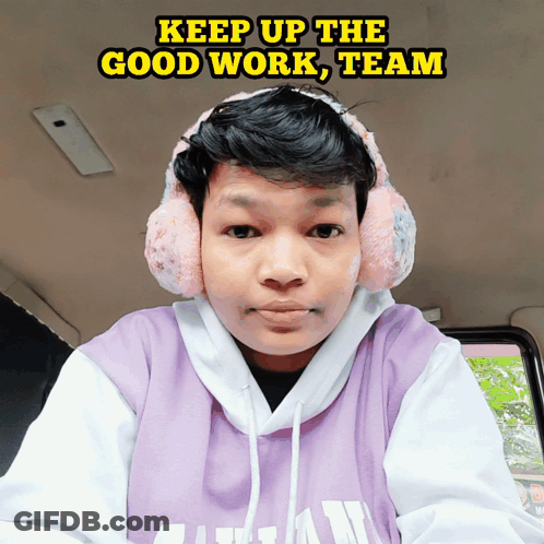 A Man Wearing Ear Muffs And A Purple Shirt With The Words Keep Up The Good Work Team Written Above Him GIF