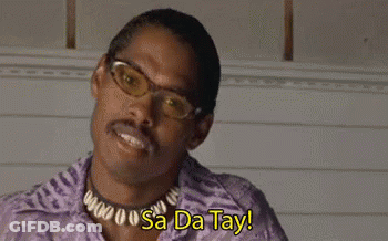 A Man Wearing Glasses , A Necklace And A Purple Shirt Is Saying Sa Da Tay . GIF