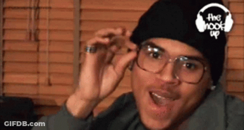 A Man Wearing Glasses And A Beanie Has The Hook Up Logo On His Hat GIF