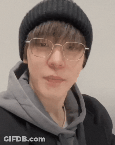 Man In Glasses And Beanie Looking At Camera GIF