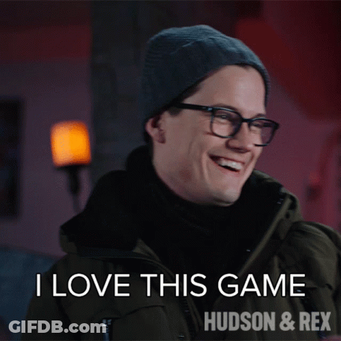 A Man Wearing Glasses And A Beanie Says I Love This Game Hudson And Rex GIF