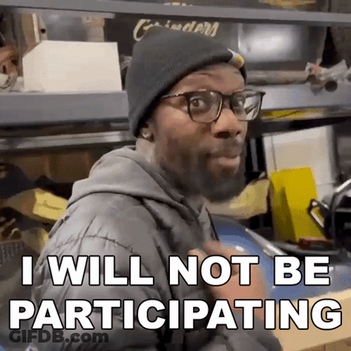 A Man Wearing Glasses And A Beanie Says That He Will Not Be Participating GIF