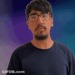A Man Wearing Glasses And A Beard Is Making A Funny Face GIF