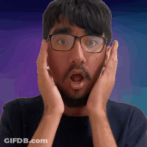 A Man Wearing Glasses And A Beard Is Making A Surprised Face GIF