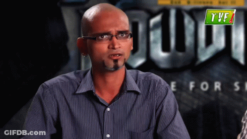 Man With Glasses And Beard In Front Of TVF GIF