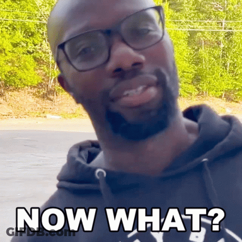 A Man Wearing Glasses And A Black Hoodie Is Asking " Now What " GIF