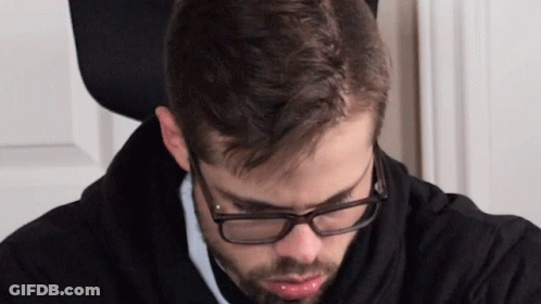 Man In Glasses And Black Hoodie Looking Down GIF