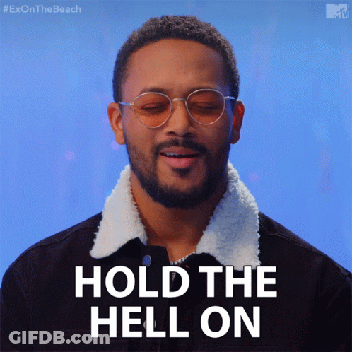A Man Wearing Glasses And A Black Jacket Says " Hold The Hell On " GIF
