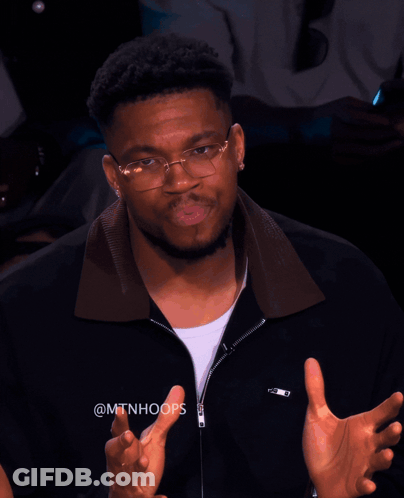 A Man Wearing Glasses And A Black Jacket With The Hashtag @Mtnhoops On It GIF