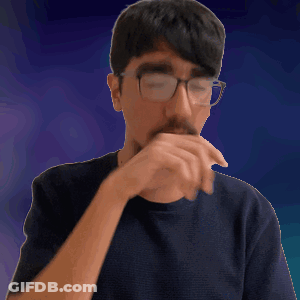 A Man Wearing Glasses And A Black Shirt Covering His Mouth With His Hand GIF