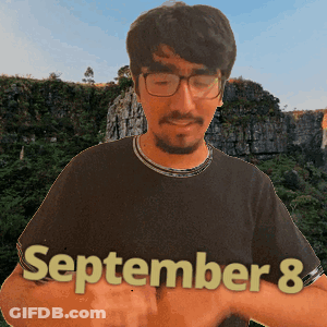 A Man Wearing Glasses And A Black Shirt Has The Date September 8 On His Shirt GIF