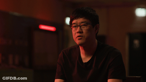 A Man Wearing Glasses And A Black Shirt Is Giving A Thumbs Up GIF