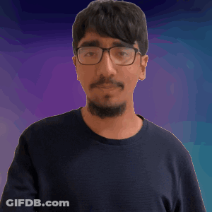 A Man Wearing Glasses And A Black Shirt Is Making A Fist GIF