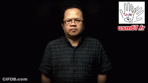 A Man Wearing Glasses And A Black Shirt Says Pour Quel Motif D' Absence GIF