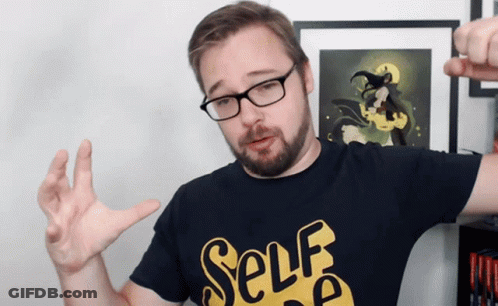 A Man Wearing Glasses And A Black Shirt That Says Self GIF
