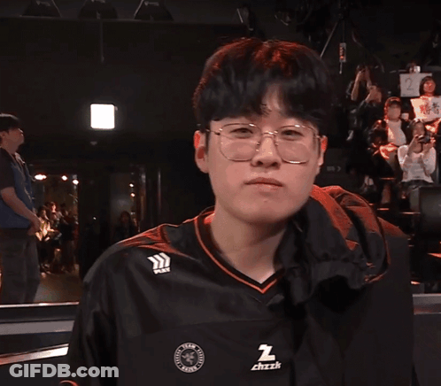 A Man Wearing Glasses And A Black Shirt That Says ' Z ' On It GIF