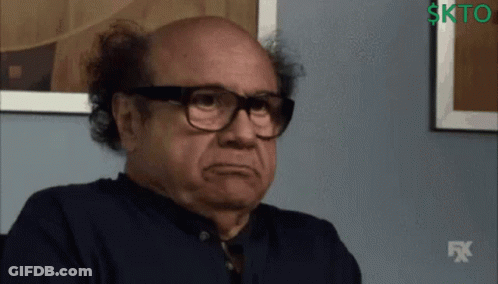 A Man Wearing Glasses And A Black Shirt With A Fx Logo In The Background GIF