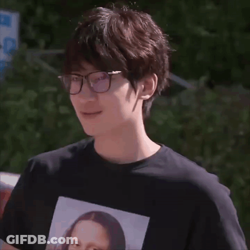 A Man Wearing Glasses And A Black Shirt With A Picture Of Mona Lisa GIF