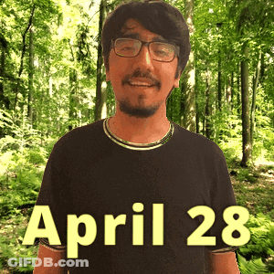 A Man Wearing Glasses And A Black Shirt With April 28 Written On It GIF