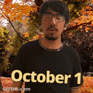 A Man Wearing Glasses And A Black Shirt With October 1 Written On It GIF