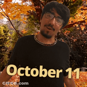 A Man Wearing Glasses And A Black Shirt With October 11 On It GIF