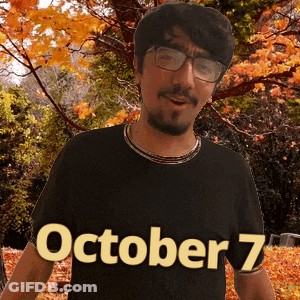 A Man Wearing Glasses And A Black Shirt With October 7 Written On It GIF