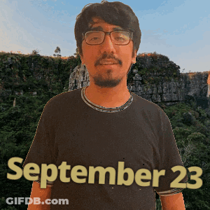 A Man Wearing Glasses And A Black Shirt With September 23 Written On It GIF