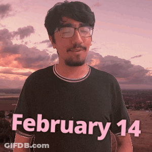 A Man Wearing Glasses And A Black Shirt With The Date February 14 On It GIF