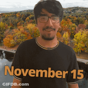 A Man Wearing Glasses And A Black Shirt With The Date November 15 On It GIF