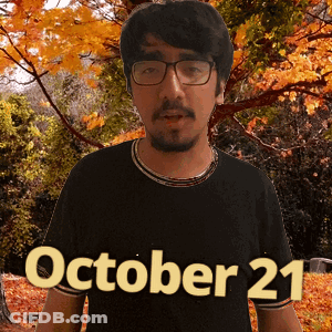 A Man Wearing Glasses And A Black Shirt With The Date Of October 21 GIF