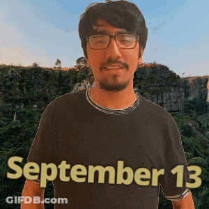 A Man Wearing Glasses And A Black Shirt With The Date September 13 On It GIF