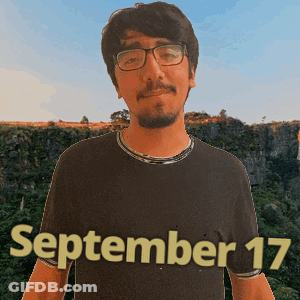 A Man Wearing Glasses And A Black Shirt With The Date September 17 Written On It GIF