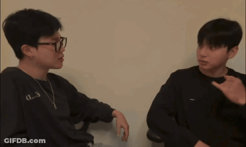 A Man Wearing Glasses And A Black Shirt With The Letter D.3 On It GIF