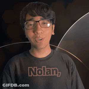 A Man Wearing Glasses And A Black Shirt With The Name Nolan On It GIF