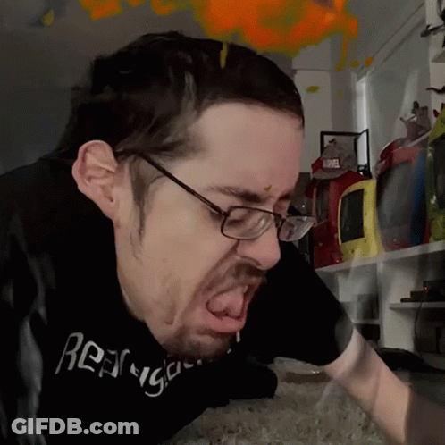 A Man Wearing Glasses And A Black T-Shirt That Says ' Rage ' On It GIF