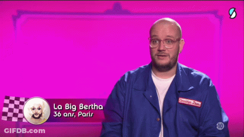 A Man Wearing Glasses And A Blue Jacket Says La Big Bertha GIF