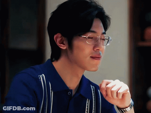 A Man Wearing Glasses And A Blue Shirt Has Ms Written On The Bottom Right GIF