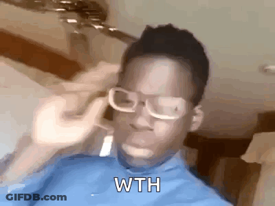 A Man Wearing Glasses And A Blue Shirt Is Holding A Fork To His Ear . GIF
