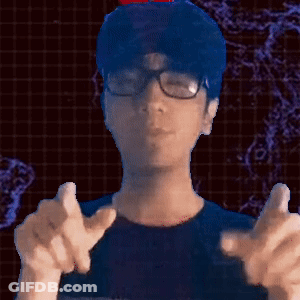 A Man Wearing Glasses And A Blue Shirt Is Pointing GIF